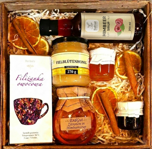 Geschenkkorb mit Tee, Honig, Sirupe, Zitronen und Marmelade